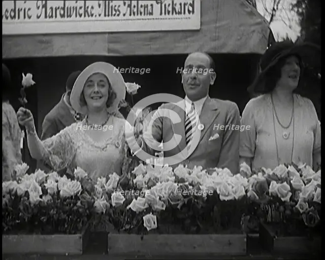 The Actors Helena Pickard and Cedric Hardwicke Holding Roses, 1920s. Creator: British Pathe Ltd.