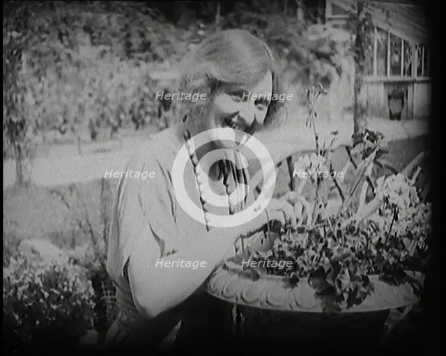 The Actress Sybil Thorndike Tending Her Flowers in a Garden, 1920s. Creator: British Pathe Ltd.