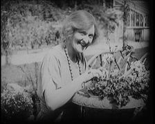 The Actress Sybil Thorndike Tending Her Flowers in a Garden, 1920s. Creator: British Pathe Ltd