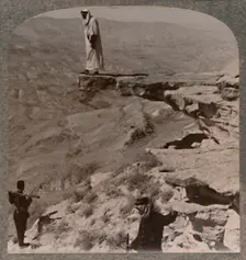 The Arno. Dragoman standing on rock c1900