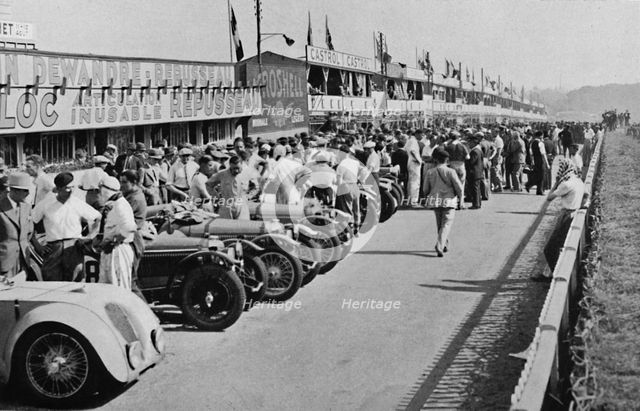 'The busy pits: before the start of Le Mans 24-hour Race', 1937. Artist: Unknown.