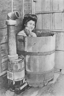 The bath is a large barrel with charcoal stove. Frequently out of doors c1900, (1921). Artist: Julian Leonard Street