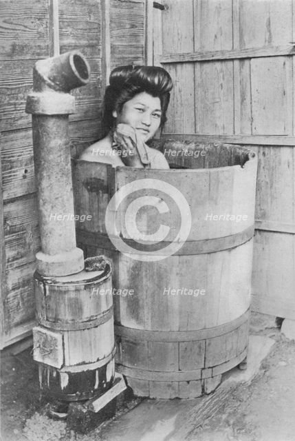 'The bath is a large barrel with charcoal stove. Frequently out of doors', c1900, (1921). Artist: Julian Leonard Street.