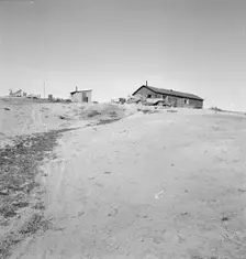 The Browning home, a partial dugout, Dead Ox Flat, Malheur County, Oregon, 1939. Creator: Dorothea Lange