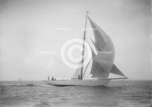 The cutter 'Westwind' sailing with spinnaker, 1912. Creator: Kirk & Sons of Cowes.