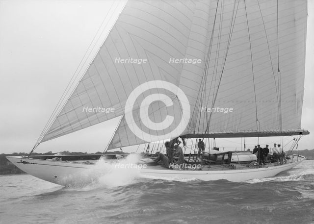 The cutter 'Minstrel' competing in the round Island Race, 1938. Creator: Kirk & Sons of Cowes.