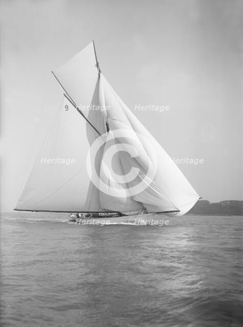 The cutter 'Rosamond' sailing with spinnaker, 1911. Creator: Kirk & Sons of Cowes.