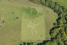 The Cerne Abbas Giant chalk hill figure and the Trendle enclosure earthwork, Dorset, 2015. Creator: Historic England