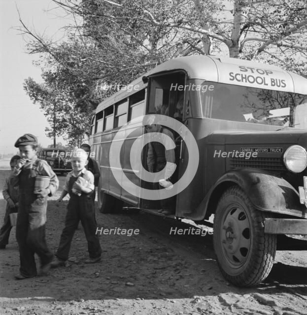 The children from Dead Ox Flat get off bus at school yard, Ontario, Oregon, 1939. Creator: Dorothea Lange.