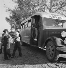 The children from Dead Ox Flat get off bus at school yard, Ontario, Oregon, 1939. Creator: Dorothea Lange