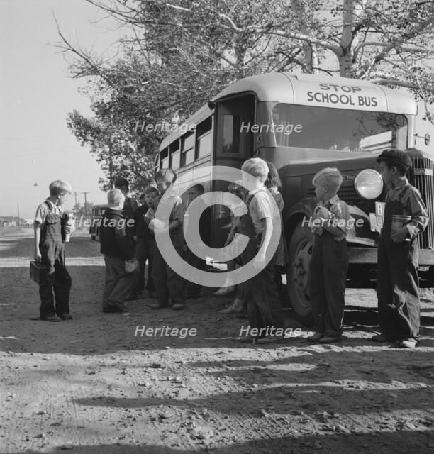 The children from Dead Ox Flat get off bus at school yard, Ontario, Oregon, 1939. Creator: Dorothea Lange.