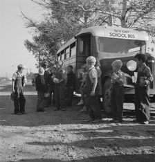 The children from Dead Ox Flat get off bus at school yard, Ontario, Oregon, 1939. Creator: Dorothea Lange