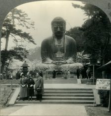 The Colossal Daibutsu in Cherry-Blossom Time - the Great Bronze Buddha of Kamakura, Japan c1930s. Creator: Unknown