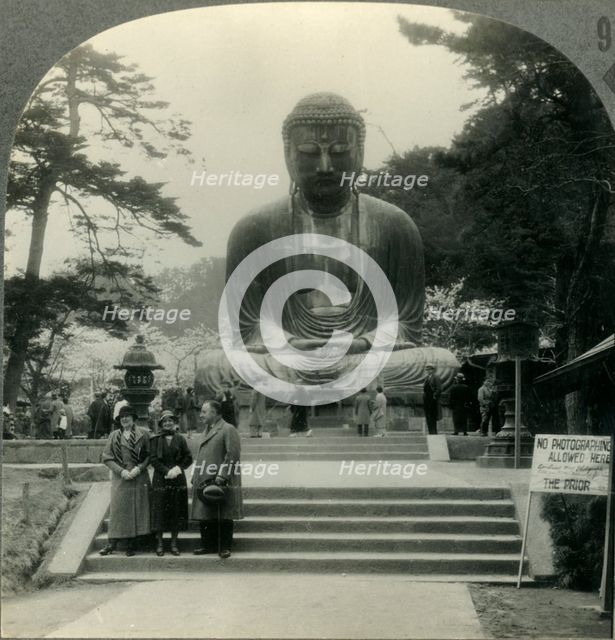 'The Colossal Daibutsu in Cherry-Blossom Time - the Great Bronze Buddha of Kamakura, Japan', c1930s. Creator: Unknown.