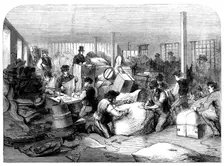 The Cotton Famine: making up parcels of clothing at the industrial institution, Manchester, 1862. Creator: Unknown