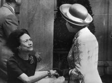 The Duchess of Windsor curtsies to the Queen outside her and the Duke's home in Paris, 1972. Creator: Unknown