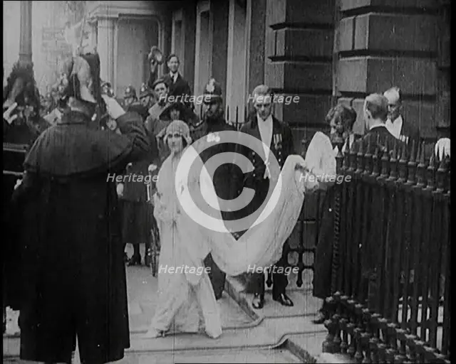 The Duke of York and Lady Elizabeth Bowes-Lyon Emerging from a House on Their Wedding Day, 1920. Creator: British Pathe Ltd.