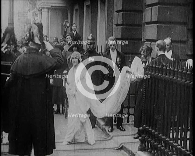 The Duke of York and Lady Elizabeth Bowes-Lyon Emerging from a House on Their Wedding Day, 1920. Creator: British Pathe Ltd.