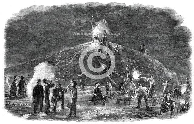 The Deptford Rifle Corps (34th Kent) forming earthworks for their shooting-ground by torchlight,1860 Creator: Unknown.