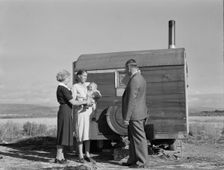 The doctor reassures the mother...the sick baby, Merrill, Klamath County, Oregon, 1939. Creator: Dorothea Lange