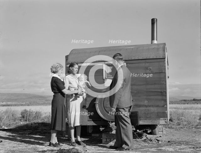 The doctor reassures the mother...the sick baby, Merrill, Klamath County, Oregon, 1939. Creator: Dorothea Lange.