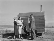 The doctor reassures the mother...the sick baby, Merrill, Klamath County, Oregon, 1939. Creator: Dorothea Lange