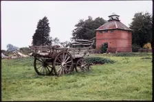 The dovecote to the south-west of Kentwell Hall seen with an old wooden wagon..., Long Melford, 1980 Creator: Dorothy Chapman