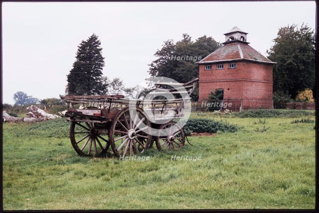 The dovecote to the south-west of Kentwell Hall seen with an old wooden wagon..., Long Melford, 1980 Creator: Dorothy Chapman.