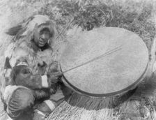The drummer-Nunivak, c1929. Creator: Edward Sheriff Curtis
