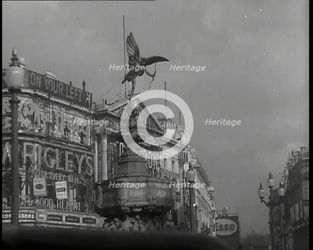 The Eros Statue in Piccadilly Circus With Neon Advertising Lights on the Buildings Behind..., 1939. Creator: British Pathe Ltd.