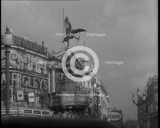 The Eros Statue in Piccadilly Circus With Neon Advertising Lights on the Buildings Behind..., 1939. Creator: British Pathe Ltd.