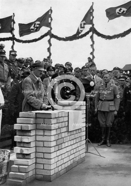The Führer puts the foundation wall to the meeting house in the Adolf-Hitler-Koog. Artist: Unknown