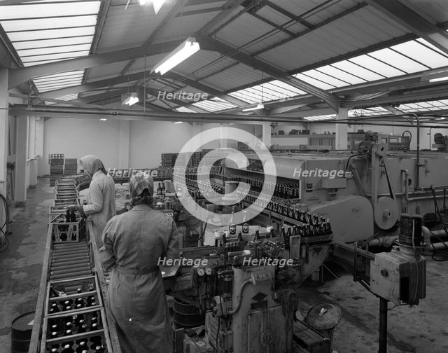 The final process of bottling beer, Ward & Sons bottling plant, Swinton, South Yorkshire, 1960. Creator: Michael Walters.