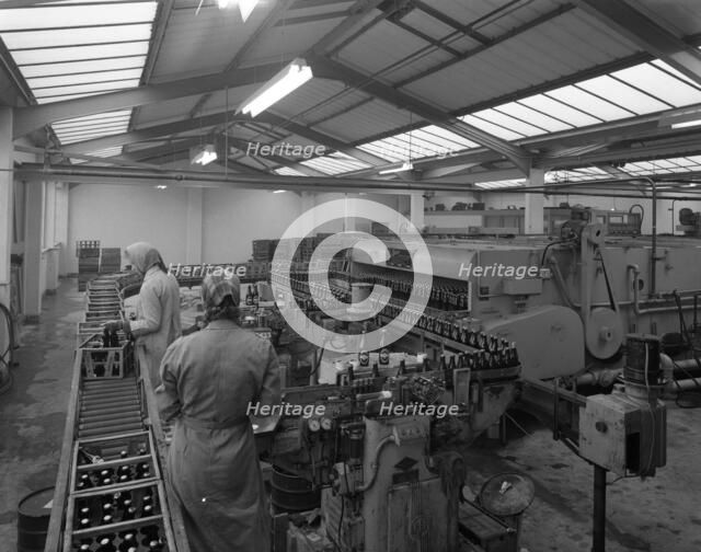 The final process of bottling beer, Ward & Sons bottling plant, Swinton, South Yorkshire, 1960. Artist: Michael Walters