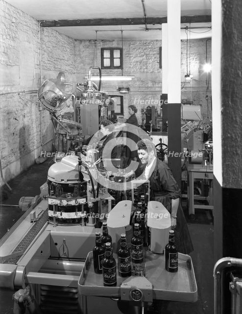 The final stages of bottling whisky at Wiley & Co, Sheffield, South Yorkshire, 1960.  Creator: Michael Walters.