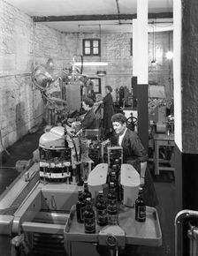 The final stages of bottling whisky at Wiley & Co, Sheffield, South Yorkshire, 1960. Creator: Michael Walters