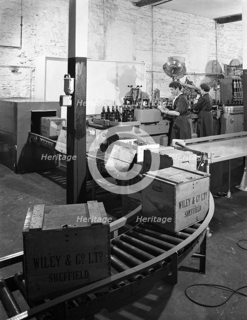 The final stages of bottling whisky at Wiley & Co, Sheffield, South Yorkshire, 1960.  Creator: Michael Walters.