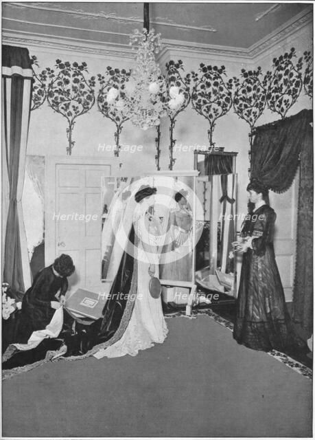 The finishing touches of a dressmaker, London, c1901 (1901). Artist: Unknown.