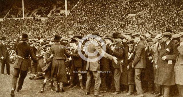 The first FA Cup Final is held at the new Wembley Stadium in London, 28 April 1923, (1935).  Creator: Unknown.