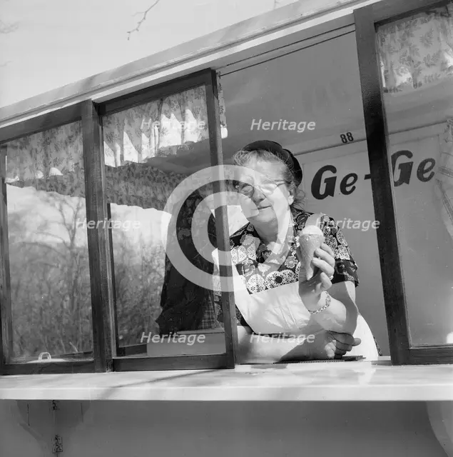 The first ice cream of the year; woman in her ice cream stall, Landskrona, Sweden, 1953. Creator: Unknown.