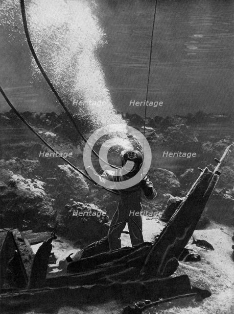 The first photograph of a diver under water, late 19th century, (c1920). Artist: Unknown