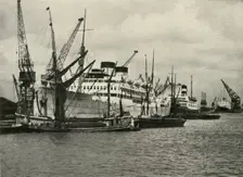 "The Forest of Masts Has Given Place to a Cluster of Steamer Funnels" Vessels Berthed at... 1937. Creator: Unknown