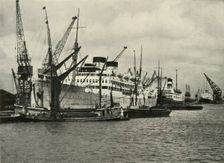 "The Forest of Masts Has Given Place to a Cluster of Steamer Funnels" Vessels Berthed at... 1937. Creator: Unknown