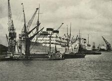 "The Forest of Masts Has Given Place to a Cluster of Steamer Funnels" Vessels Berthed at... 1937. Creator: Unknown