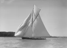 The gaff rigged cutter Bloodhound sailing downwind under spinnaker, 1911. Creator: Kirk & Sons of Cowes