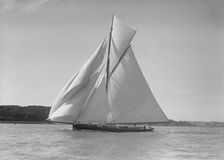 The gaff rigged cutter Bloodhound sailing downwind under spinnaker, 1911. Creator: Kirk & Sons of Cowes