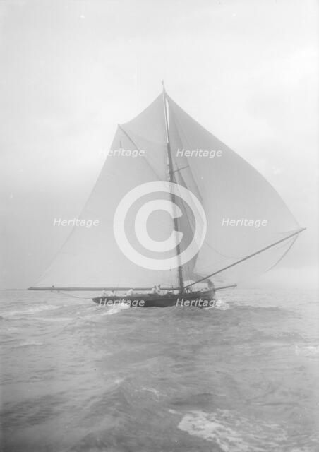The gaff rigged cutter 'Bloodhound' sailing downwind under spinnaker, August 1912. Creator: Kirk & Sons of Cowes.