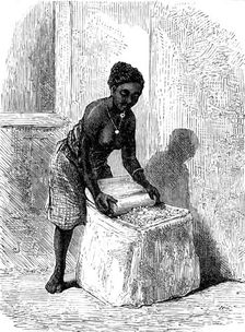 The Gold Coast and Ashantee War: woman grinding corn at Accra, 1873. Creator: Unknown