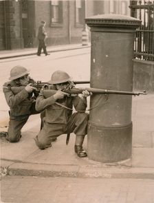 The Home Guard find cover behind a pillar box during a enemy engagement rehearsal, 1941