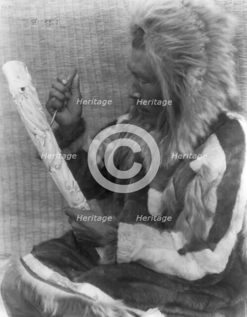 The ivory carver-Nunivak, c1929. Creator: Edward Sheriff Curtis.